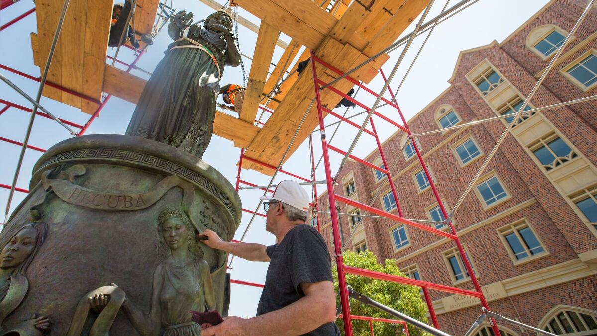 Christopher Slatoff makes some finishing touches on his sculpture at USC.