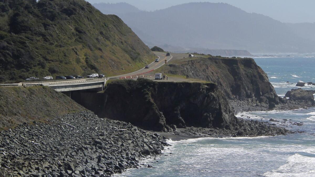 CHP investigators work at the scene where a family's car plunged off a cliff near Highway 1.