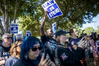 ONTARIO, CA - SEPTEMBER 26, 2023: Striking United Auto Worker Michael Carter, 59, cheers during a rally in front of the Stellantis Mopar facility on September 26, 2023 in Ontario, California. He has been with the company for 29 years. When he started, Carter said that this was a job that lifted him up. "I came home from Desert Storm. I didn't have a job and I had no direction. This company hired me. I was making almost $16 an hour and that was pretty good then. Now, I'm making $30. A $15 increase in 29 years just isn't good." For the younger workers it is much worse, he said. "And they keep taking things from us. They took away our pensions. They took away some of our five minute breaks. They took away our bonus checks. They have never given any of that back. Now, we don't even have cost of living increases. This has to change."(Gina Ferazzi / Los Angeles Times)