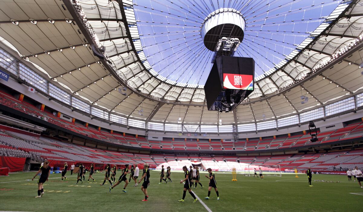 U.S. players run drills during a practice for the Women's World Cup final under the open roof of BC Place.