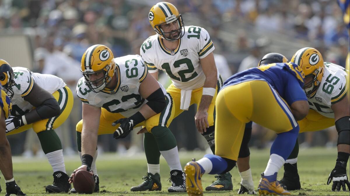 Green Bay Packers quarterback Aaron Rodgers begins his pre-snap count.