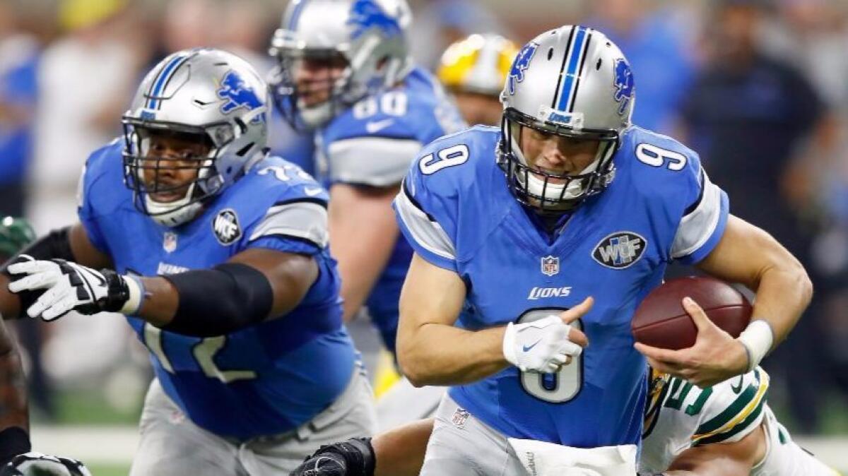 Lions quarterback Matthew Stafford, shown running against the Packers during a Jan. 1 game, wears a glove on his throwing hand that covers a splint on the dislocated tip of his middle finger.