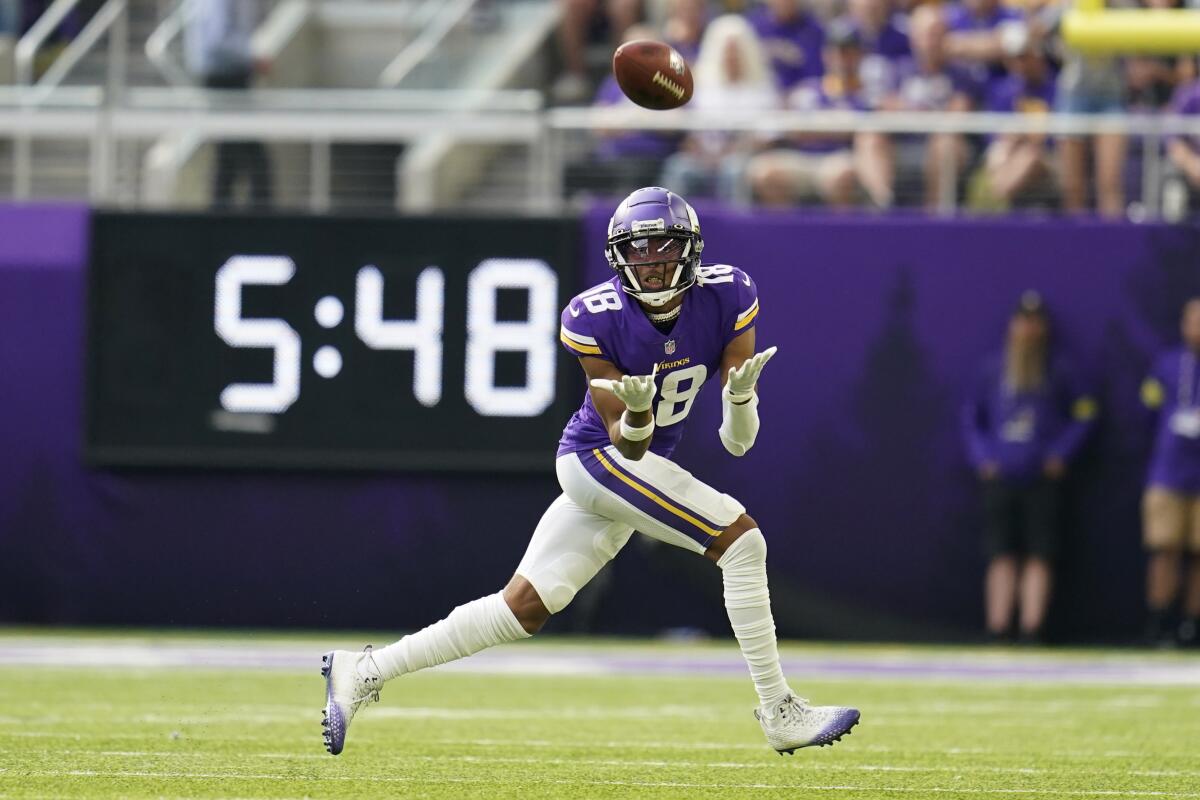 Minnesota Vikings wide receiver Justin Jefferson (18) catches a pass during the first half of an NFL football game against the Green Bay Packers, Sunday, Sept. 11, 2022, in Minneapolis. (AP Photo/Abbie Parr)