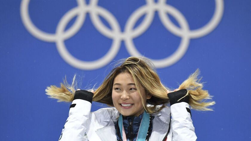 Southern California snowboarder Chloe Kim on the podium after winning gold in the Olympic halfpipe.