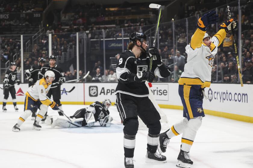 Nashville Predators center Yakov Trenin, right, celebrates after scoring against.