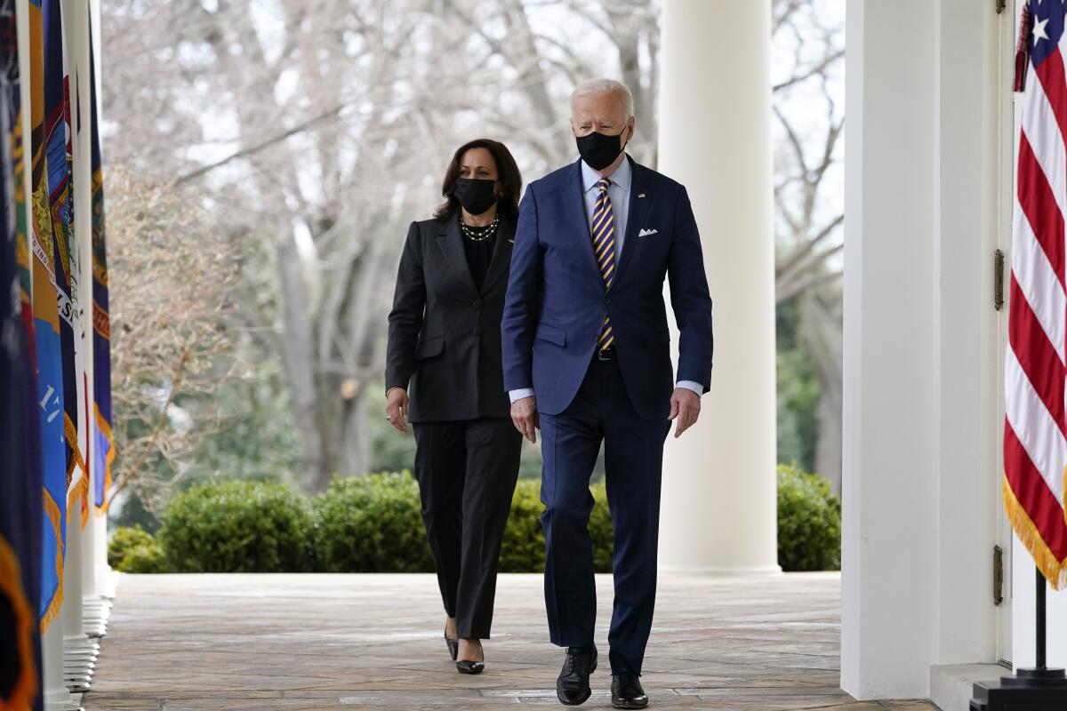 President Joe Biden and Vice President Kamala Harris walk to the Rose Garden of the White House.