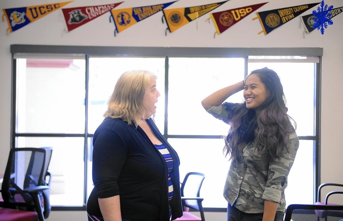 Jodi Balma, president of the Honors Transfer Counsel of California and coordinator of the honors program at Fullerton College, left, chats with student Justine Banal in the school's transfer center.