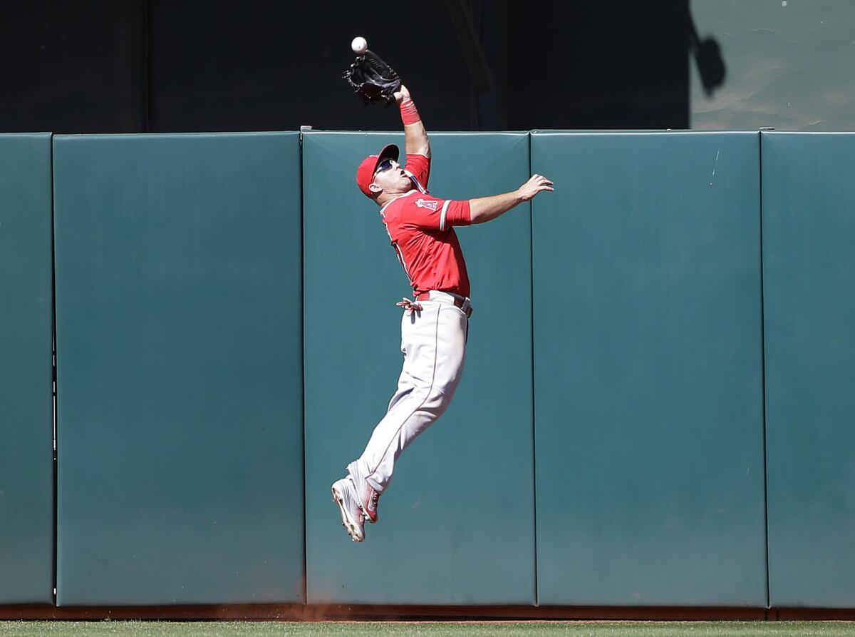 Angels center fielder Mike Trout makes a leaping catch for the final out of the game on an Ike Davis fly ball with the bases loaded on April 30. The Angels beat the Athletics, 6-5.