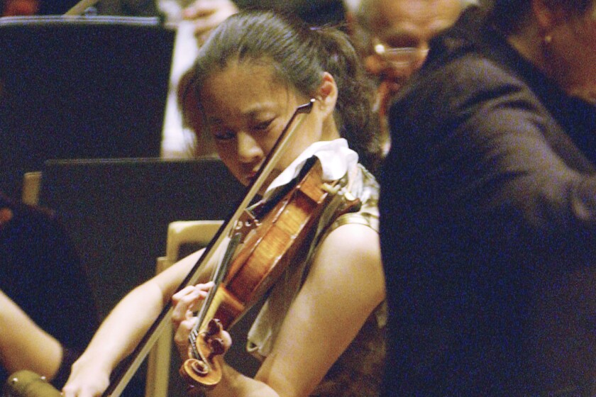 FILE - In this Oct. 14, 2005 file photo, Violinist Midori performs with New York Philharmonic conducted by Marin Alsop at Lincoln Center in New York. This year’s Kennedy Center Honors will be a slimmed-down affair as the nation emerges from the coronavirus pandemic. The 43rd class of honorees includes country music legend Garth Brooks, dancer and choreographer Debbie Allen, actor Dick Van Dyke, singer-songwriter Joan Baez and violinist Midori. (AP Photo/Osamu Honda)