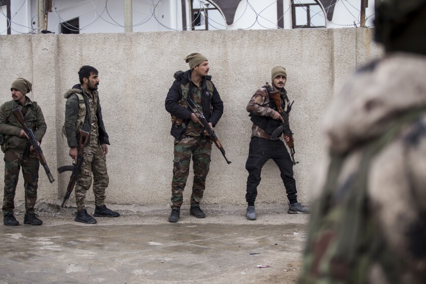 Syrian Democratic Forces soldiers hold a position in Hassakeh, northeast Syria, Thursday, Jan. 27, 2022. Dozens of armed Islamic State militants remained holed up in the last occupied section of a Syrian prison, U.S.-backed Kurdish-led forces said Thursday. The two sides clashed a day after the Syrian Democratic Forces announced they had regained full control of the facility. (AP Photo/Baderkhan Ahmad)