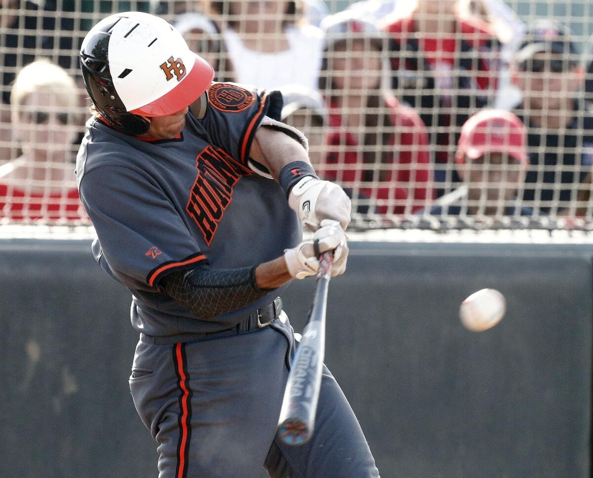 Huntington Beach High's Brett Barrera hits a leadoff single in the seventh inning against Studio City Harvard-Westlake in a CIF Southern Section Division 1 semifinal playoff game on Tuesday.
