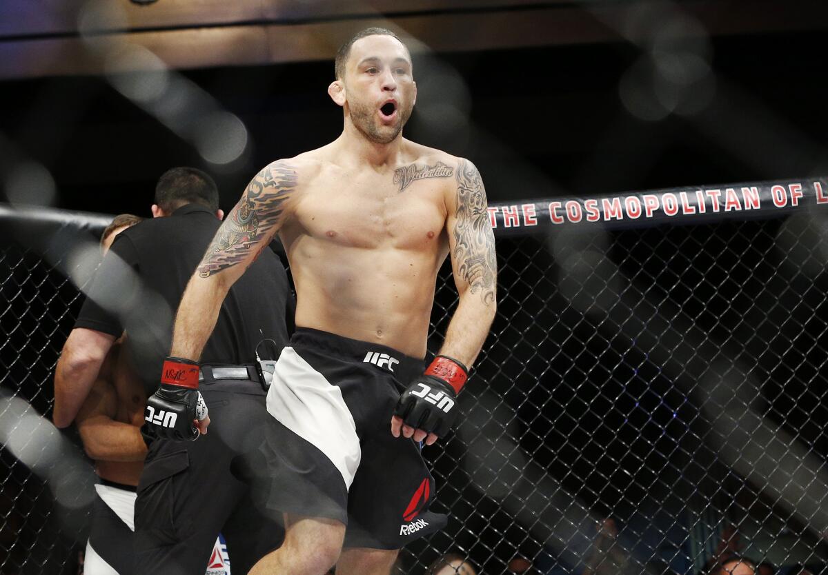 Frankie Edgar celebrates after defeating Chad Mendes with a first-round knockout in a featherweight bout on Dec. 11, 2015.