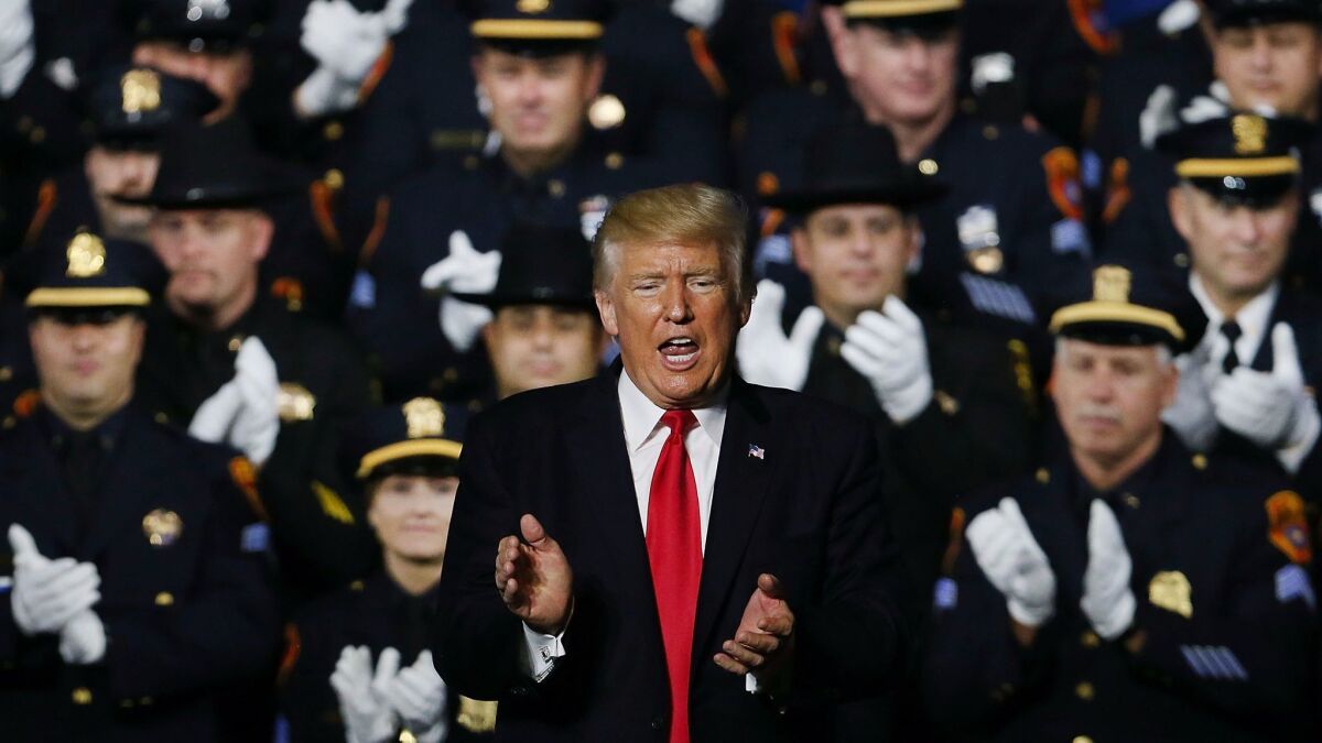 President Donald Trump speaks at Suffolk Community College Friday in Brentwood, N.Y., where he encouraged "rough" handling of people arrested by law enforcement. "Please don't be too nice," he said.