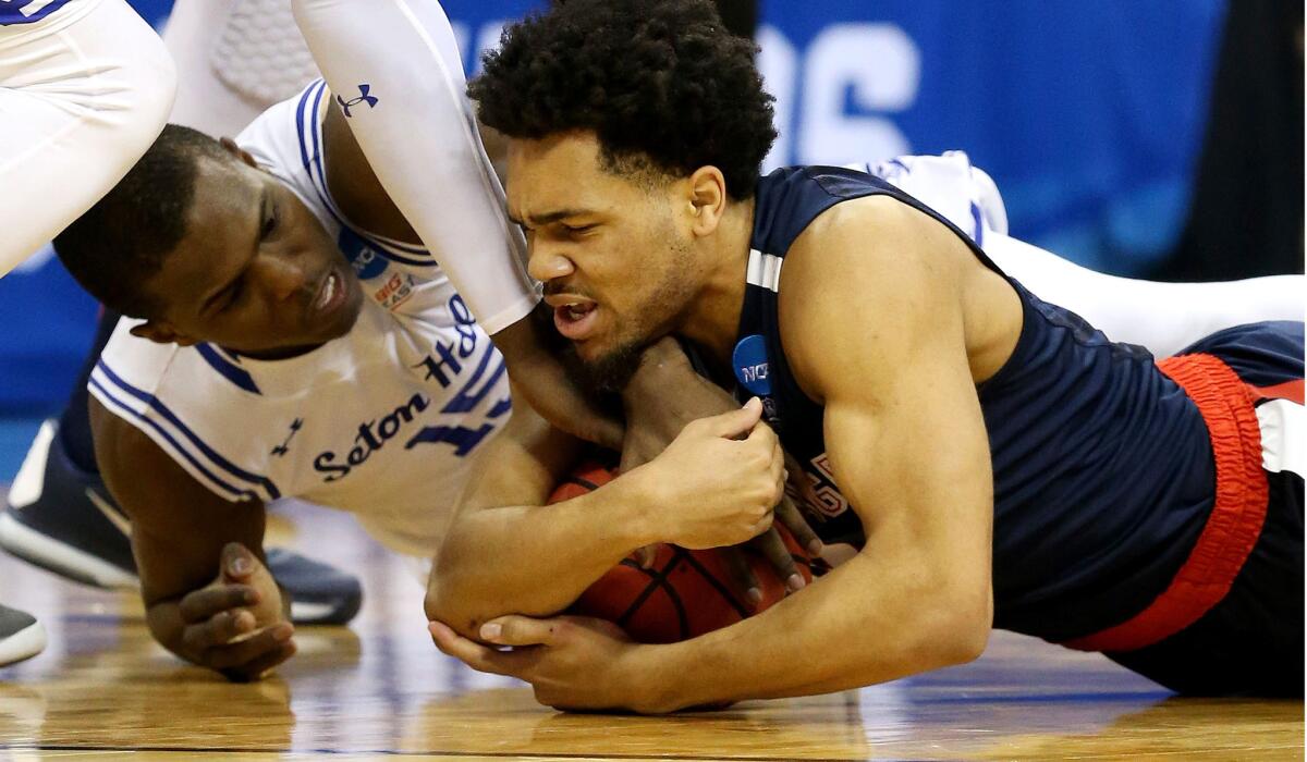 Gonzaga's Silas Melson and Seton Hall's Isaiah Whitehead dive for a loose ball in the first half.