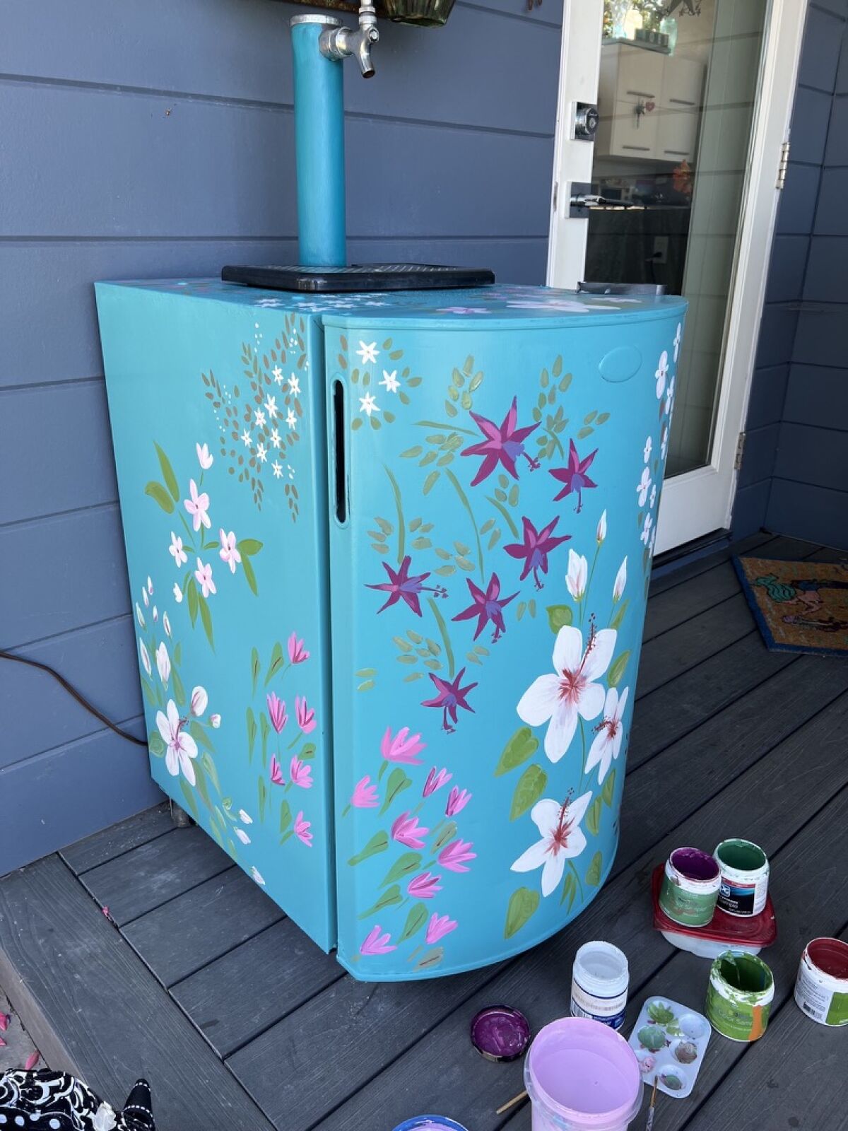 Diane Lehman's floral painting gave new vibrancy to this formerly "rusted and awful” kegerator outside Jill Johnson's home.