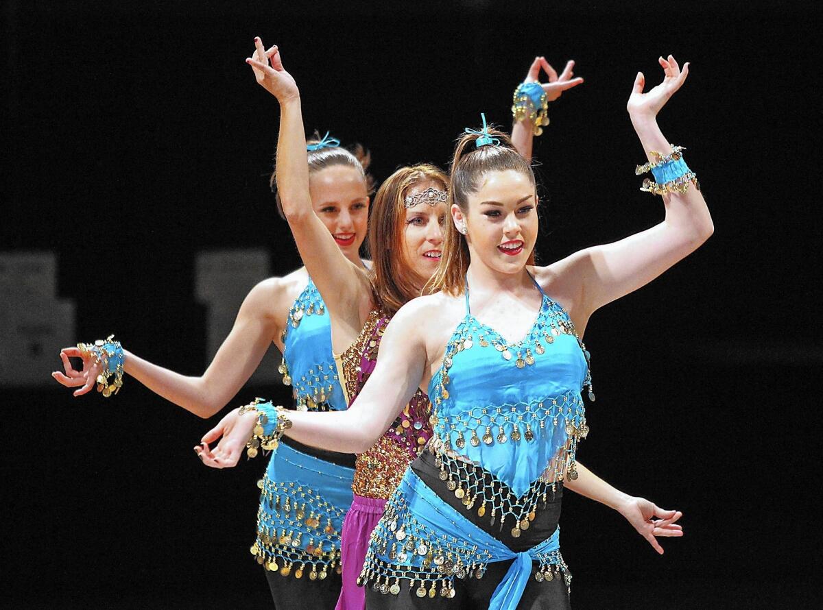 Environmental Science teacher Kim Rapp dances Bollywood style with partners Gwynn Tanner, left, and Madalyn Risser, during the Corona del Mar High fourth annual Dancing with the Teachers performance on Thursday in the school gym.