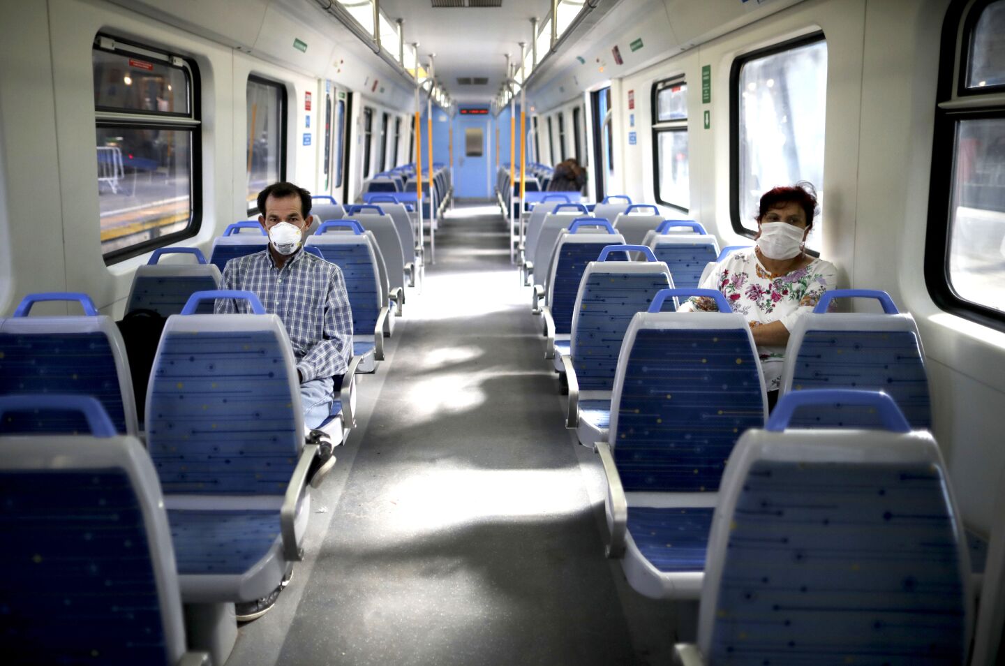 Argentina: People wearing masks as a precaution against the spread of the new coronavirus ride a nearly empty train in Buenos Aires.