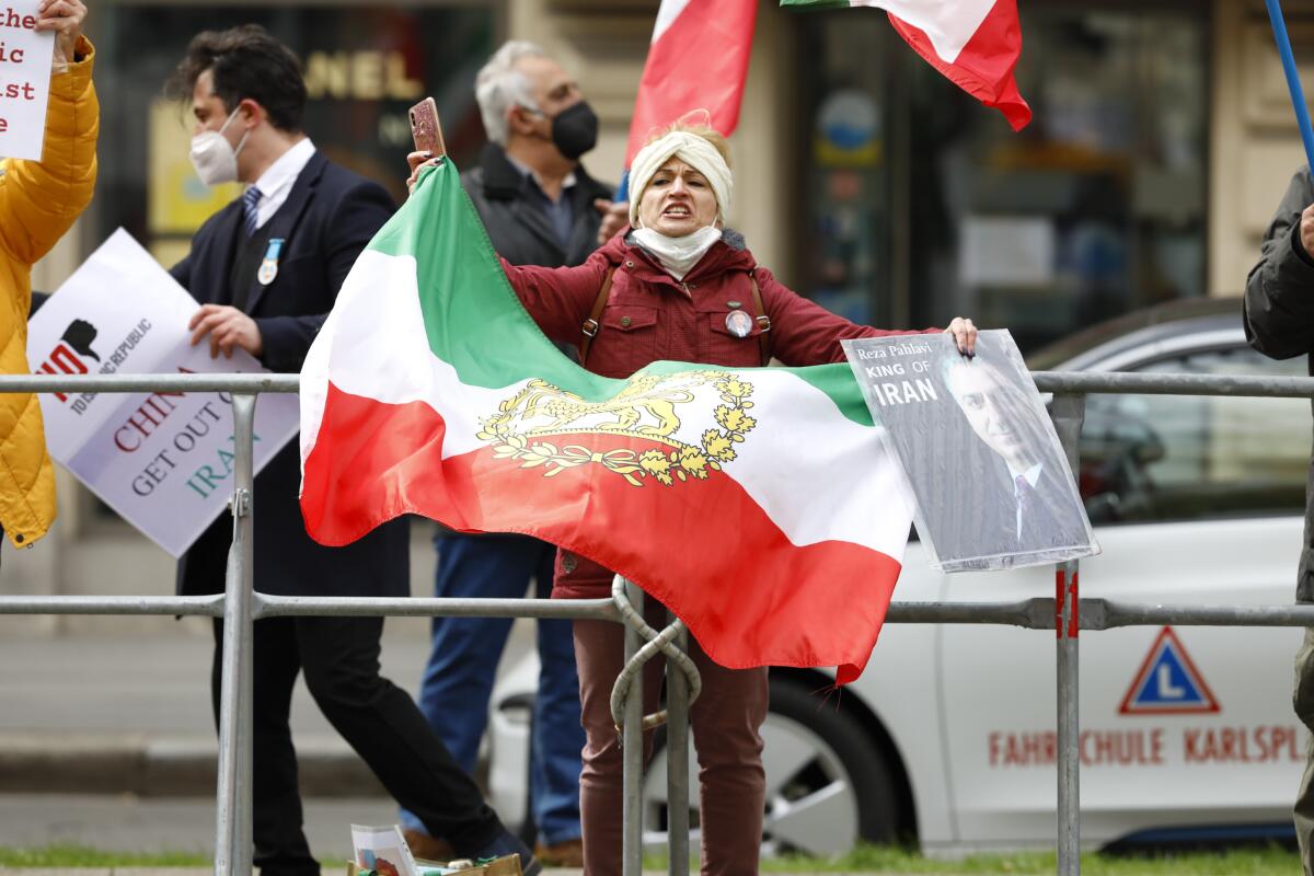 Demonstrators of an Iranian opposition group protest near the Grand Hotel Wien where closed-door nuclear talks with Iran take place, in Vienna, Austria, Thursday, April 15, 2021. (AP Photo/Lisa Leutner)