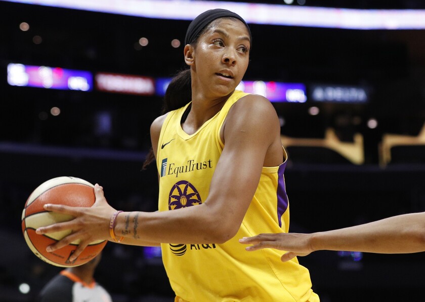 Sparks forward Candace Parker, defended by Phoenix Mercury forward Brianna Turner looks to pass at Staples Center.