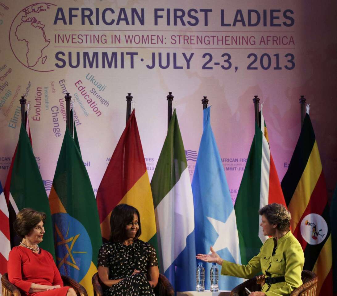 Former U.S. First Lady Laura Bush sits next to current U.S. First Lady Michelle Obama and moderator Cokie Roberts at the African First Ladies Summit in Dar Es Salaam