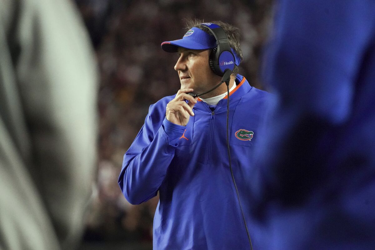 Florida head coach Dan Mullen watches from the sideline during the first half of the team's NCAA college football game against South Carolina on Saturday, Nov. 6, 2021, in Columbia, S.C. (AP Photo/Sean Rayford)