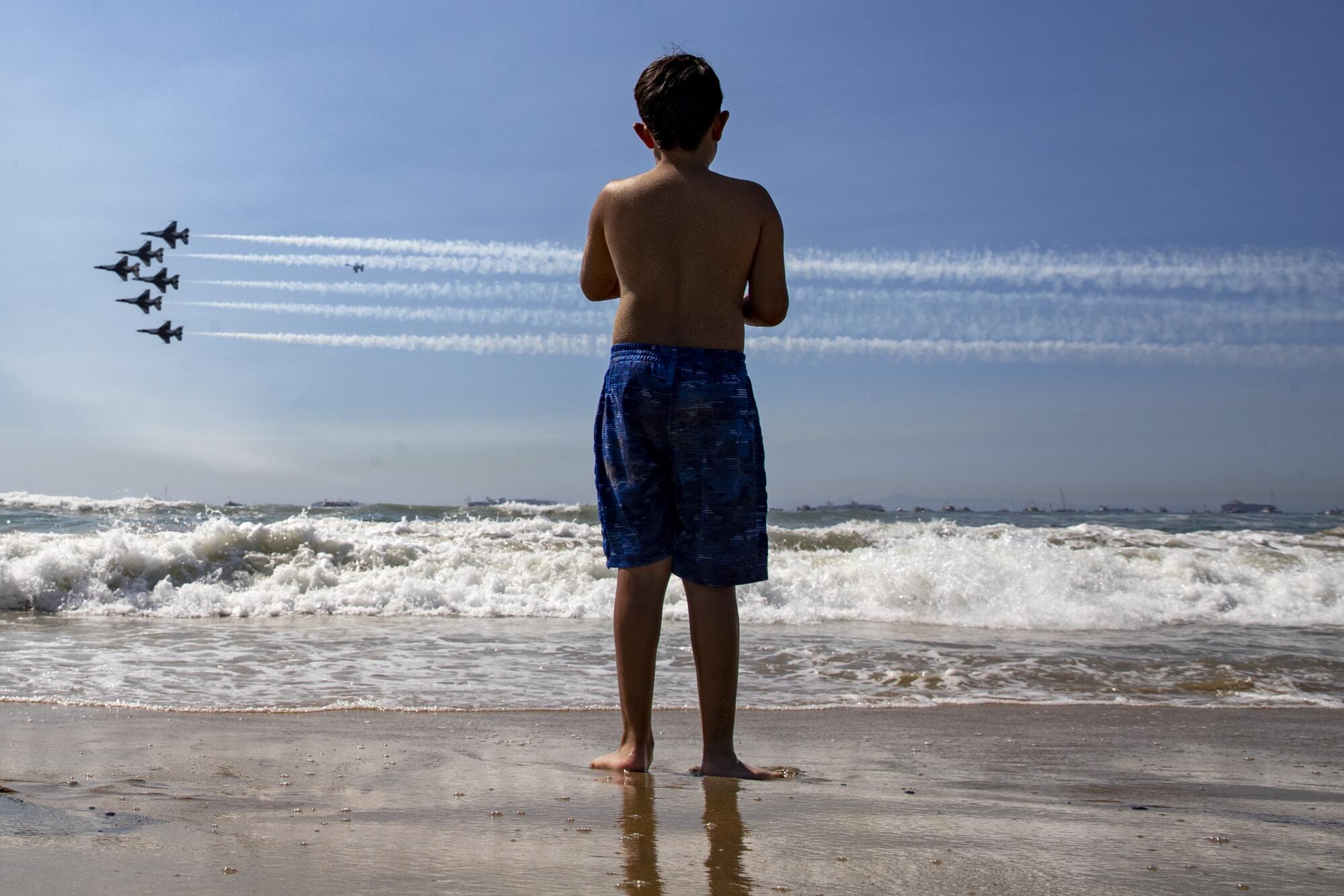  Ari Anival, 8, watches as the U.S. Air Force Thunderbirds streak across the sky.