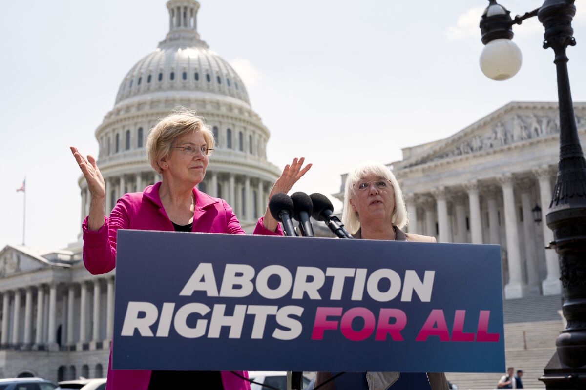 FILE - Sen. Elizabeth Warren, D-Mass., and Sen. Patty Murray, D-Wash., talk to reporters as the Supreme Court is poised to possibly overturn Roe v. Wade, at the Capitol in Washington, June 15, 2022. The Democratic National Committee is launching a digital ad campaign to energize its voters after last month’s Supreme Court decision overturning Roe v. Wade. The ad campaign warns that Republicans’ ultimate goal is to outlaw abortion nationwide. (AP Photo/J. Scott Applewhite, File)