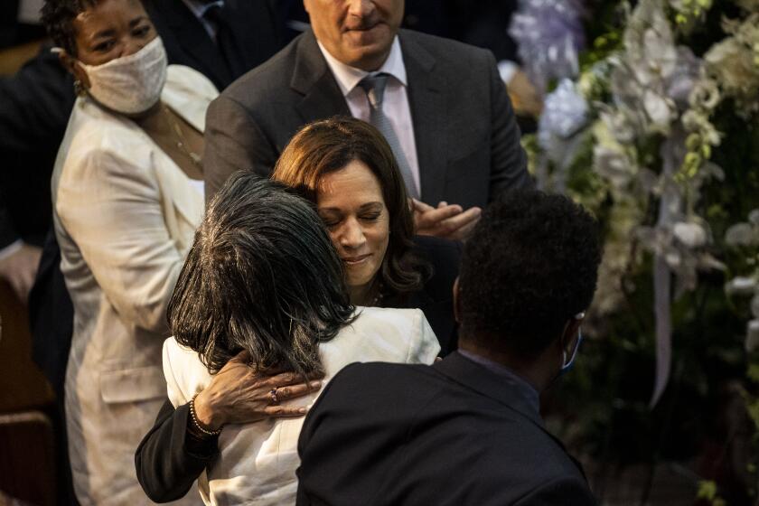 BUFFALO, NY - MAY 28: Vice President Kamala Harris hugs Robin Harris, daughter of Ruth Whitfield, as Angela Crawley, Second Gentleman Doug Emhoff, and Garnell Whitfield Jr., look in during the funeral of Ruth Whitfield at Mt. Olive Baptist Church, on Saturday, May 28, 2022 in Buffalo, NY. Mrs. Whitfield was one of ten people killed two weeks ago in what federal officials are calling an act of "racially motivated violent extremism," by a white man, in the shooting of a supermarket in a historically black neighborhood of Buffalo, NY. (Kent Nishimura / Los Angeles Times)