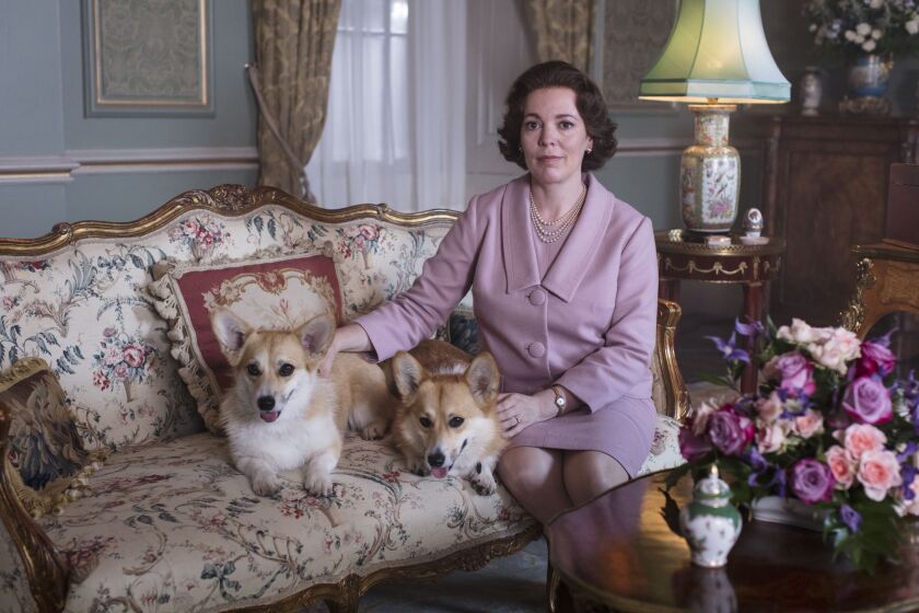 Olivia Colman as Queen Elizabeth II, with two adorable corgis, in Season 3 of Netflix's 'The Crown.' The Oscar winner takes over the role this season from Claire Foy.