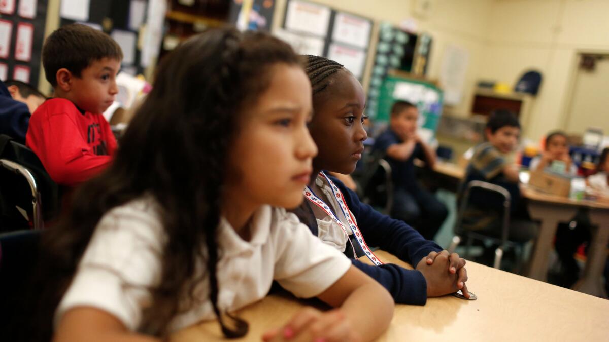 Elementary school students listen to their teacher at Ann Street Elementary School in 2014.