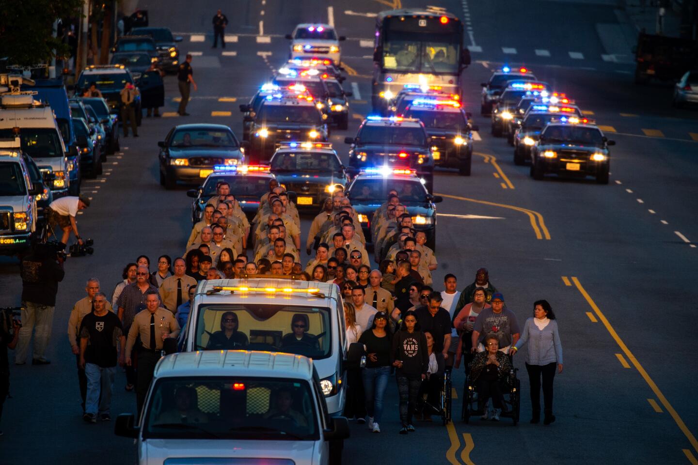 A procession escorts the body of L.A. County Sheriff's Deputy Joseph Solano along Marengo Street from County-USC Medical Center to the coroner's office on Wednesday.