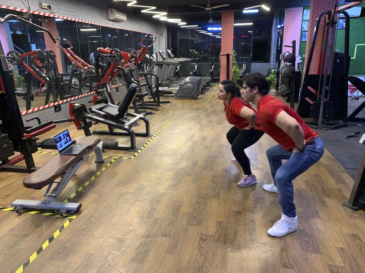 New Delhi gym owners Bijender and Kanika Gautam lead an online class at their closed gym.