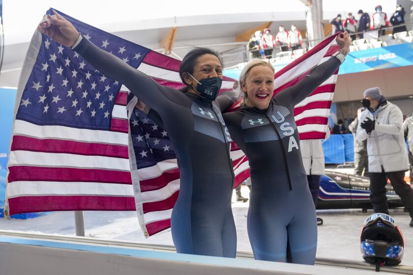 Kaillie Humphries, of the United States, right, and her teammate Elana Meyers Taylor celebrate.