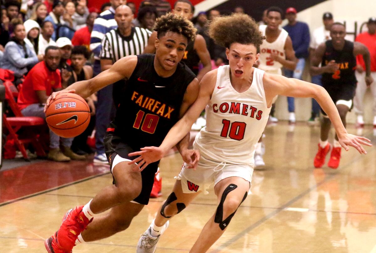 Fairfax guard Keith Dinwiddie drives against Westchester's T.J. Wainwright during their Western League game on Dec. 13, 2019.