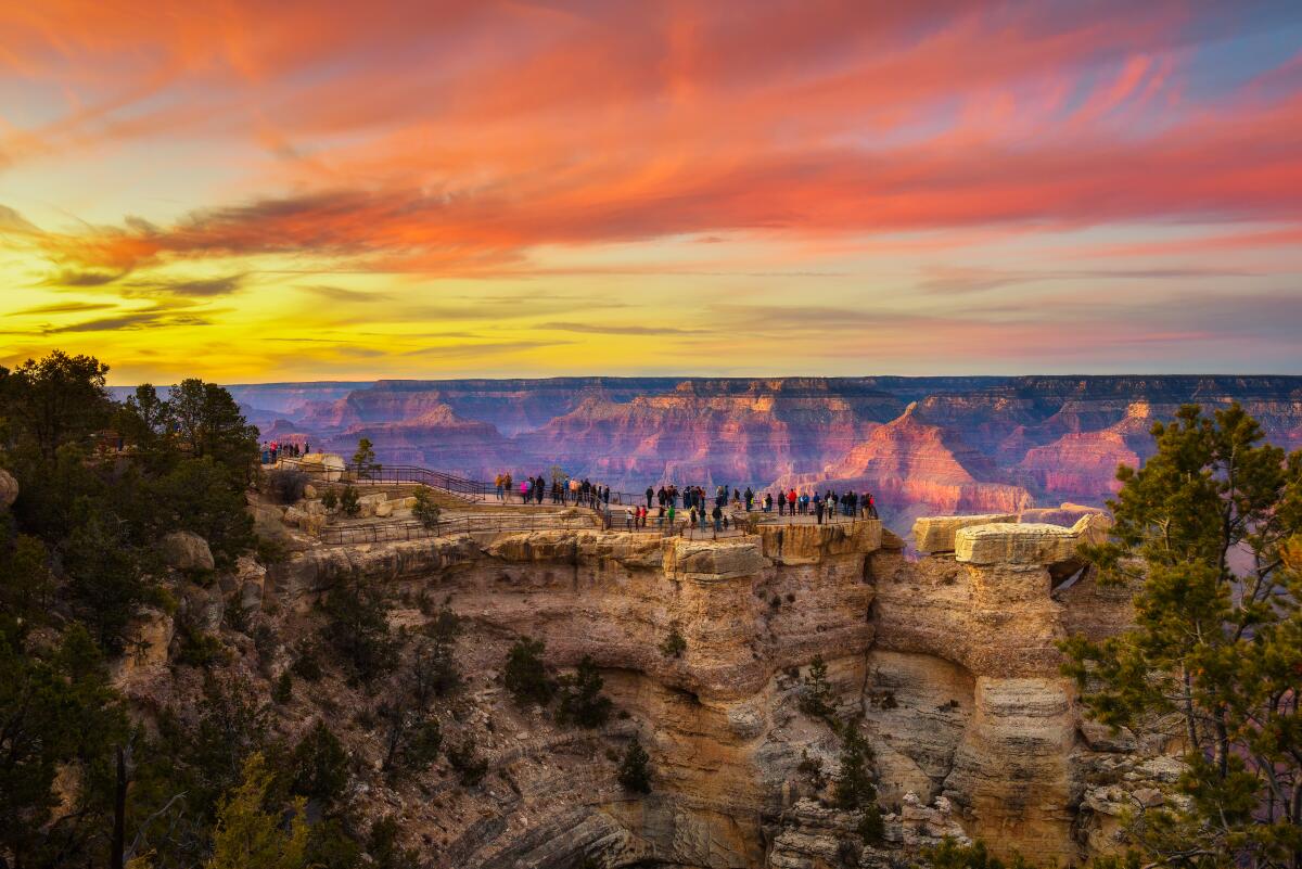 Visitors enjoy the beautiful sunset from Mather Point.