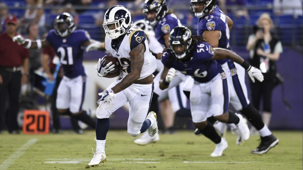 Rams running back John Kelly rushes the ball against Baltimore on Aug. 9.