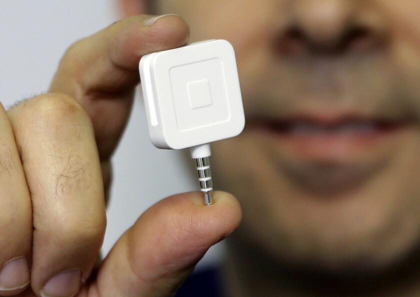 FILE - Dr. Greg Werner poses for a picture with his Square credit card reader at his office in New York on Jan. 5, 2015. Square Inc., the San Francisco-based payments company headed by former Twitter CEO Jack Dorsey, announced Wednesday, Dec. 1, 2021, that it is changing its name to Block. (AP Photo/Seth Wenig, File)
