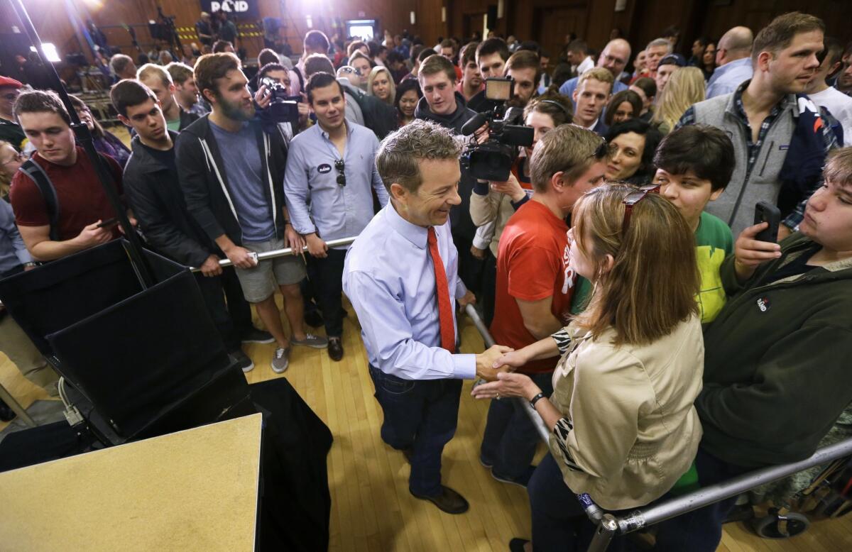 Republican presidential candidate Sen. Rand Paul, R-Ky., greets a supporter during a rally at the University of Iowa on Friday.