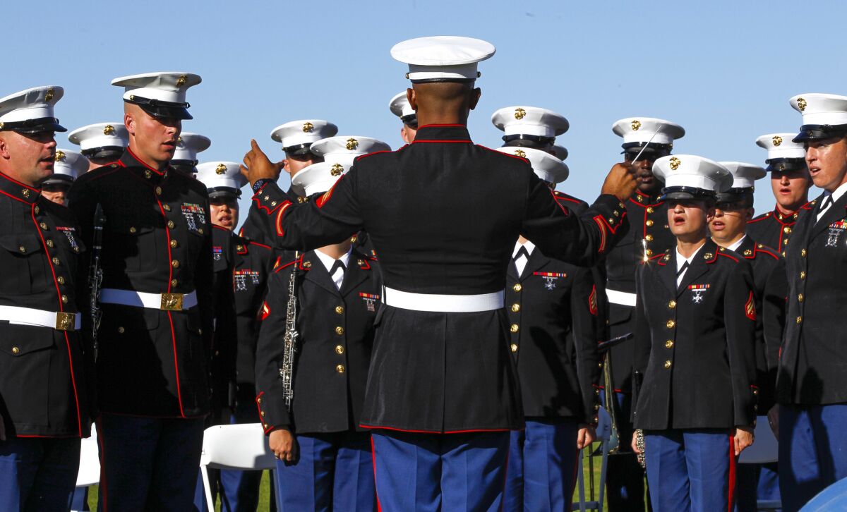 Marine Sgt. Yiliami Fihaki, center, conducts the Marine Band San Diego as they sing during the Veterans Day Ceremony.