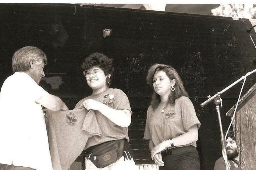 Guadalupe Rodriguez Corona, center, presents a club shirt to Cesar Chavez.