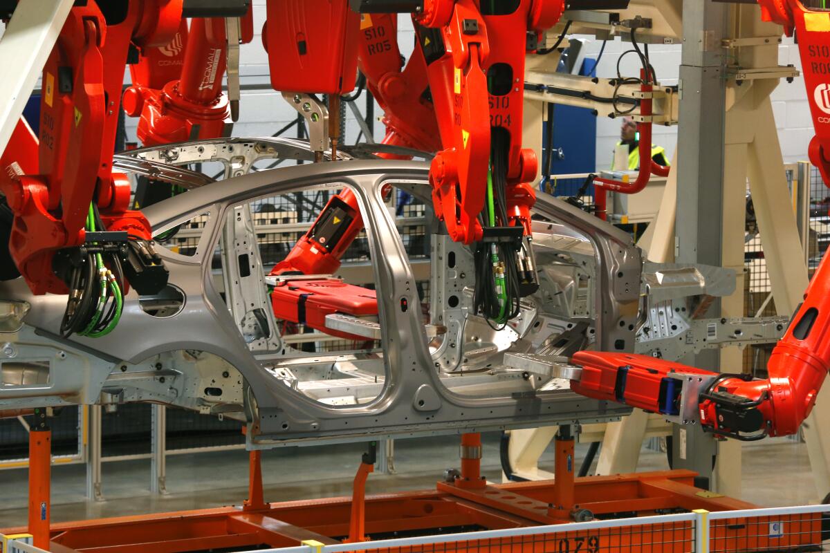 Robots help build a car.