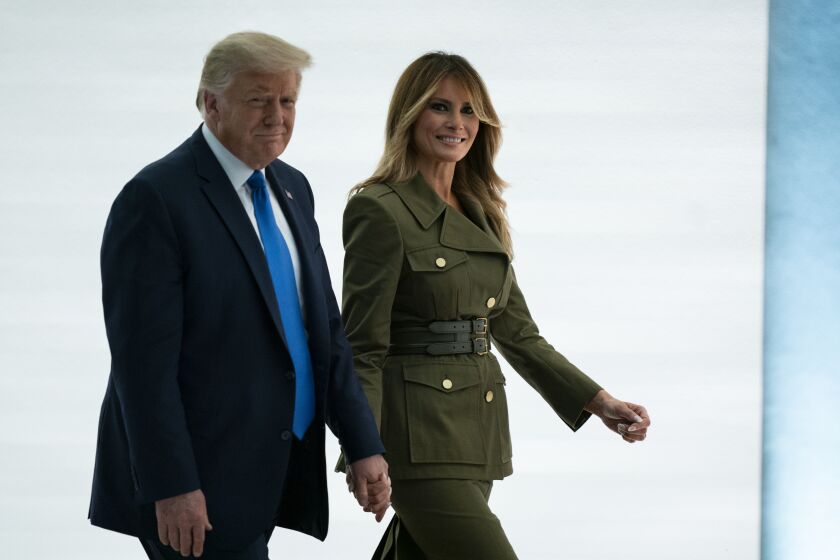 President Donald Trump walks with Melania Trump after her speech to the 2020 Republican National Convention from the Rose Garden of the White House, Tuesday, Aug. 25, 2020, in Washington. (AP Photo/Evan Vucci)