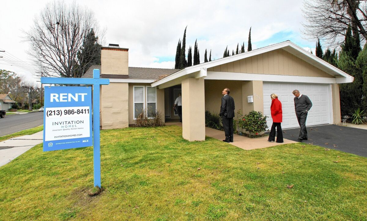 Executives from Invitation Homes, a subsidiary of Blackstone Group, tour a home in Canoga Park that the company bought, fixed up and turned into a rental property. Blackstone has bet billions on the housing recovery, acquiring 44,000 homes nationwide.