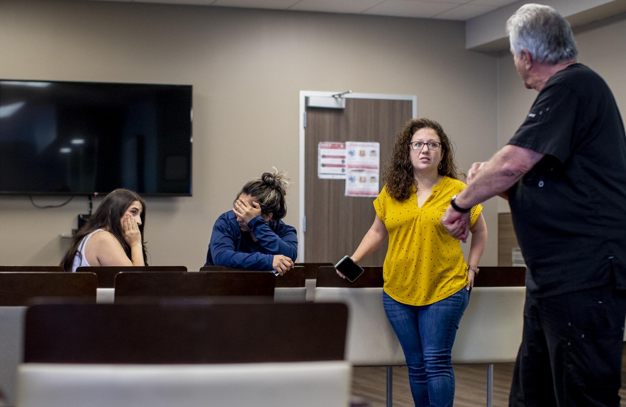 Dr Alan Braid, right, with Andrea Gallegos, the clinic's executive administrator, begin to informs patients 