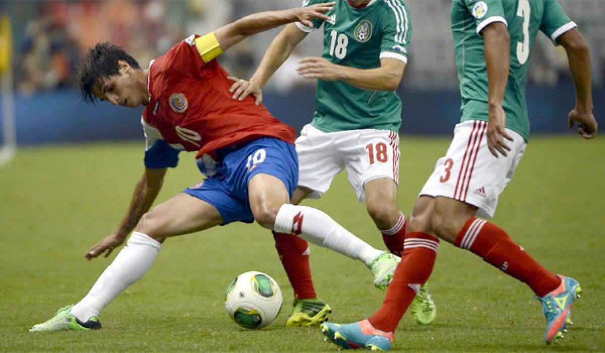 Costa Rica's Bryan Ruiz tries to control the ball in front of two Mexican defenders as both teams played out to a 0-0 tie in a World Cup qualifying match in Mexico City on Tuesday.