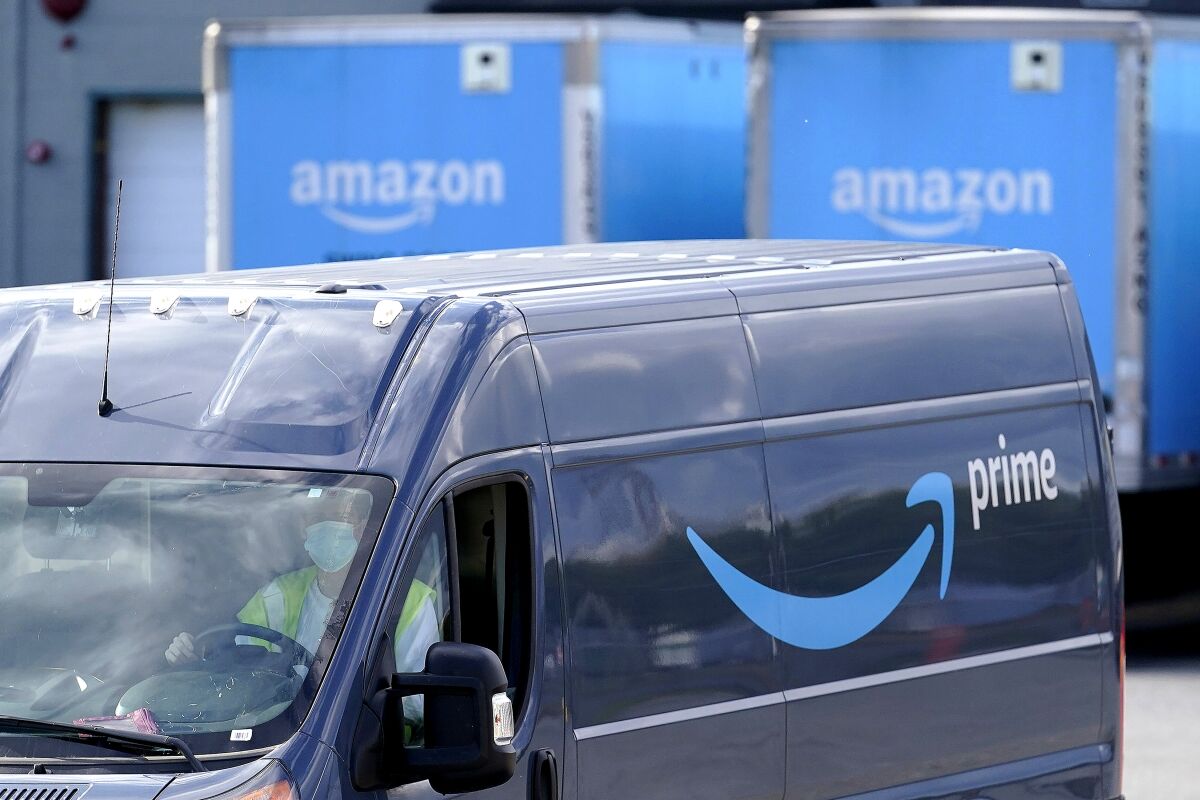 FILE - An Amazon Prime logo is seen on the side of a delivery van as it departs an Amazon Warehouse location on Oct. 1, 2020, in Dedham, Mass. Amazon will be offering discounts on a variety of items during its two-day Prime Day shopping event that began Tuesday, July 12, 2022. Consumers are searching for the best deals they can find, including time-sensitive deals that are offered on the site for a short period of time. (AP Photo/Steven Senne, File)