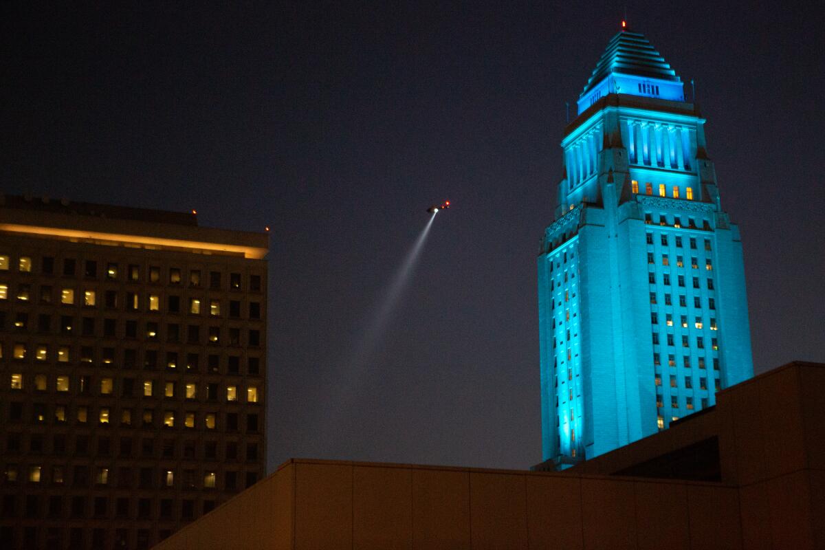 An LAPD helicopter hovers over a protest in 2020