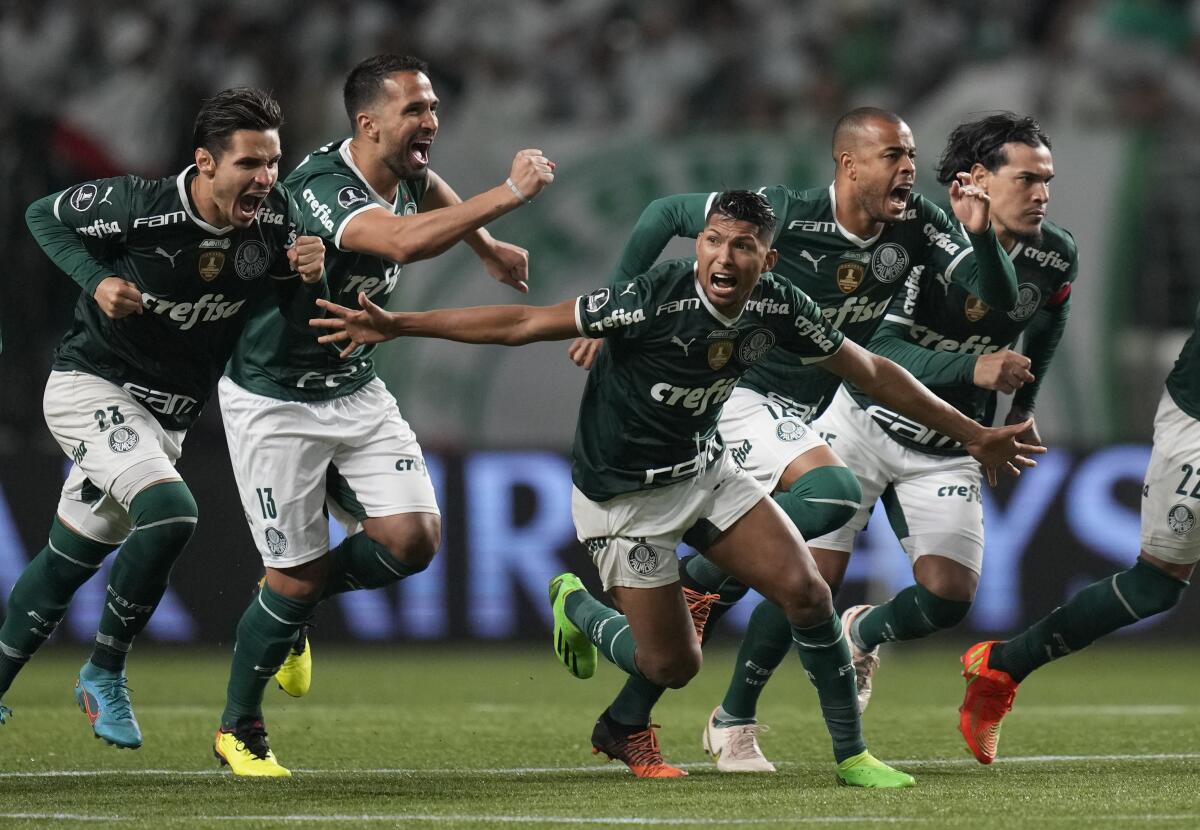 Players of Brazil's Palmeiras celebrate their team's 6-5 win over Brazil's Atletico Mineiro in a penalty shoot-out during a Copa Libertadores quarter final second leg soccer match at Allianz Parque stadium in Sao Paulo, Brazil, Wednesday, Aug. 10, 2022. (AP Photo/Andre Penner)