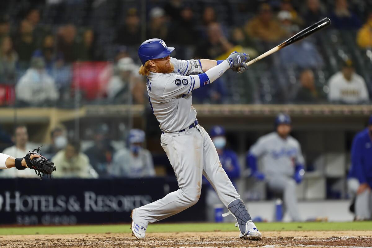 Dodgers third baseman Justin Turner hits a run-scoring single against the Padres in the ninth inning Friday.