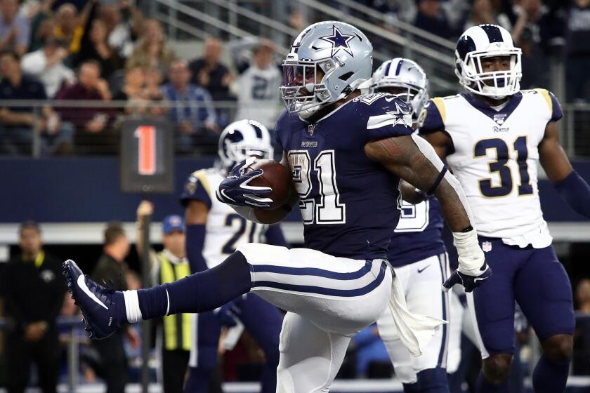 ARLINGTON, TEXAS - DECEMBER 15: Ezekiel Elliott #21 of the Dallas Cowboys runs for a touchdown against the Los Angeles Rams in the second quarter at AT&T Stadium on December 15, 2019 in Arlington, Texas. (Photo by Ronald Martinez/Getty Images)